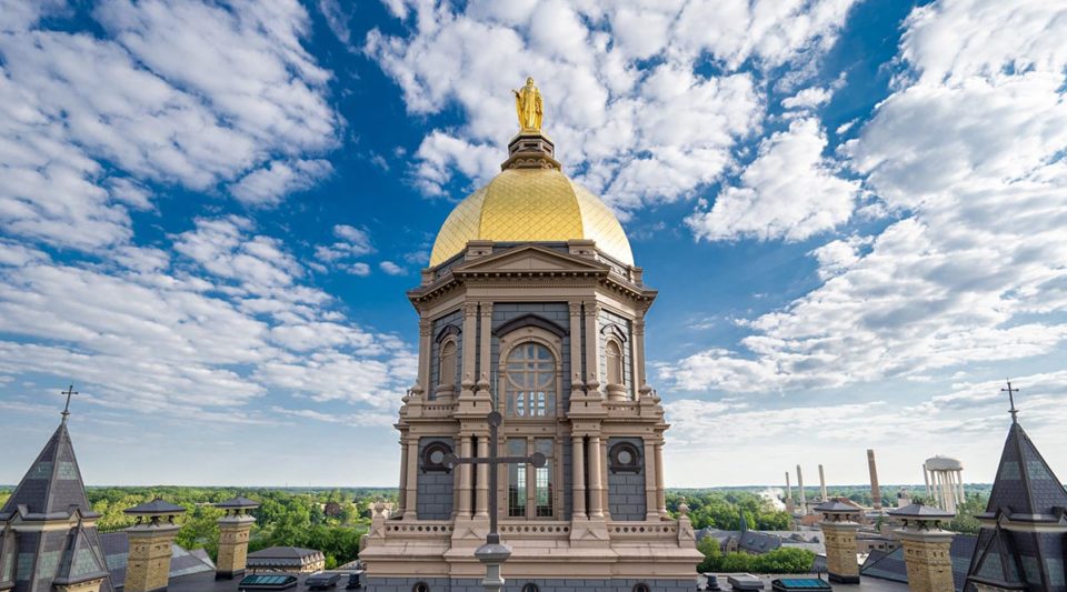 Main Building with blue sky and clouds behind.