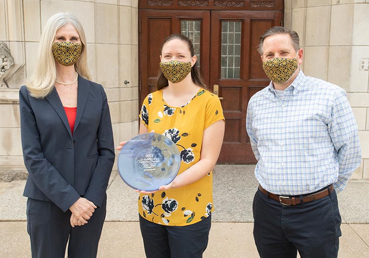 Standing with Dean Trish Culligan and CBE Chair Bill Schneider, Prof. Jennifer Schaefer accepts the 2021 ND Women in Engineering Impact Award.