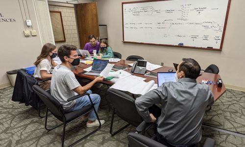 Students with Geno Acosta in CEEES conference room