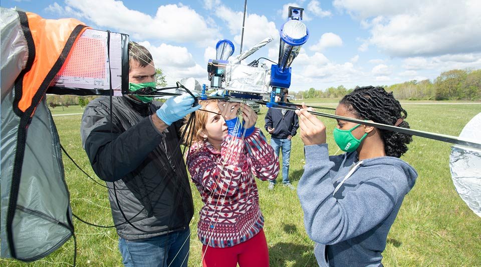 IrishSat team members making adjustments to the payload before launch