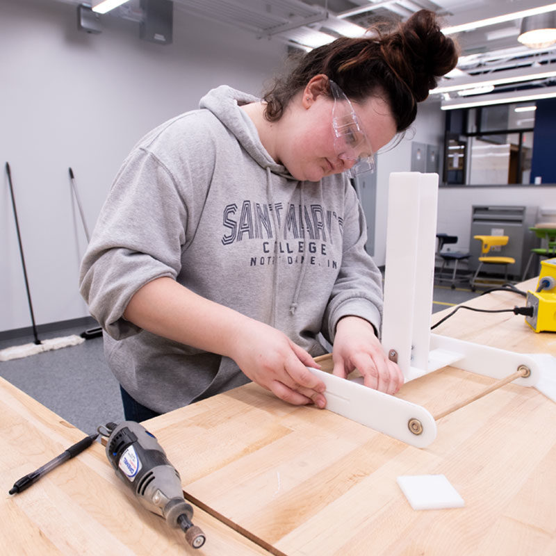 Female student assembling pieces of her project in the Engineering Innovation Hub