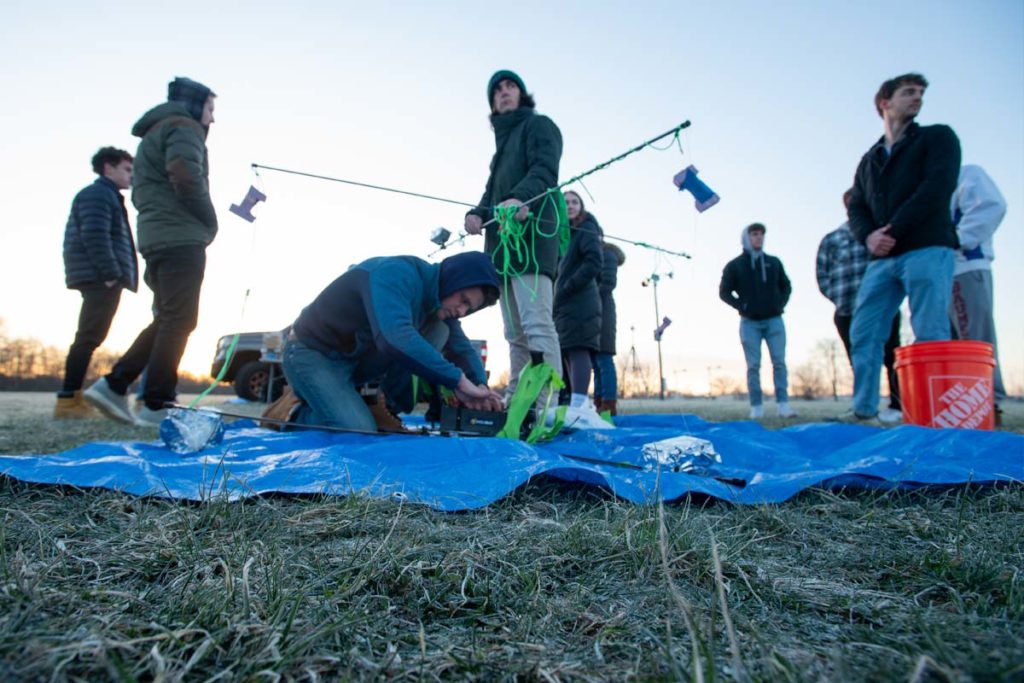 Members of IrishSAT assembling components in the early morning sunlight