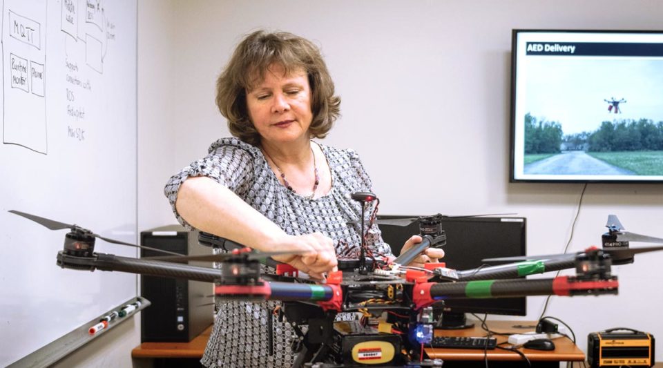 Jane Cleland-Huang inspecting a large drone