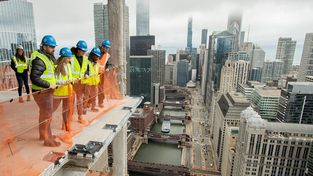 Students overlooking the Chicago river from the construction site