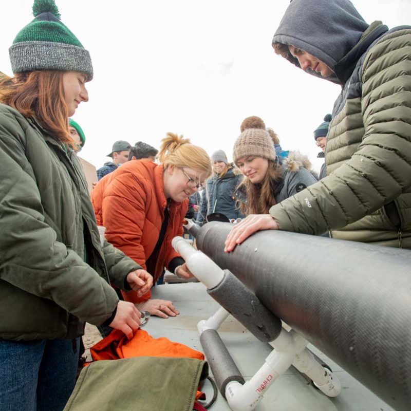 ND Rocketry team members inspecting the rocket