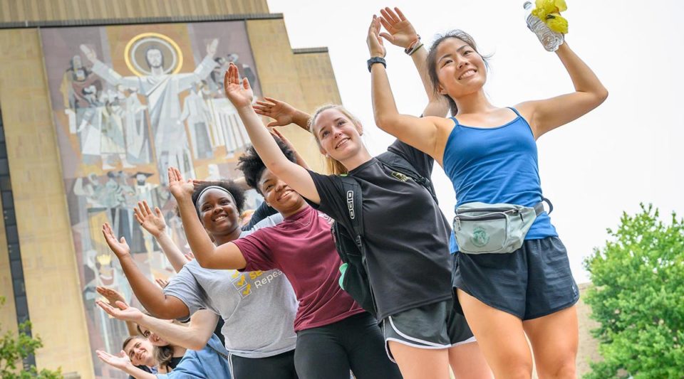 Graduate students participating in an orientation event in front of Hesburgh Library