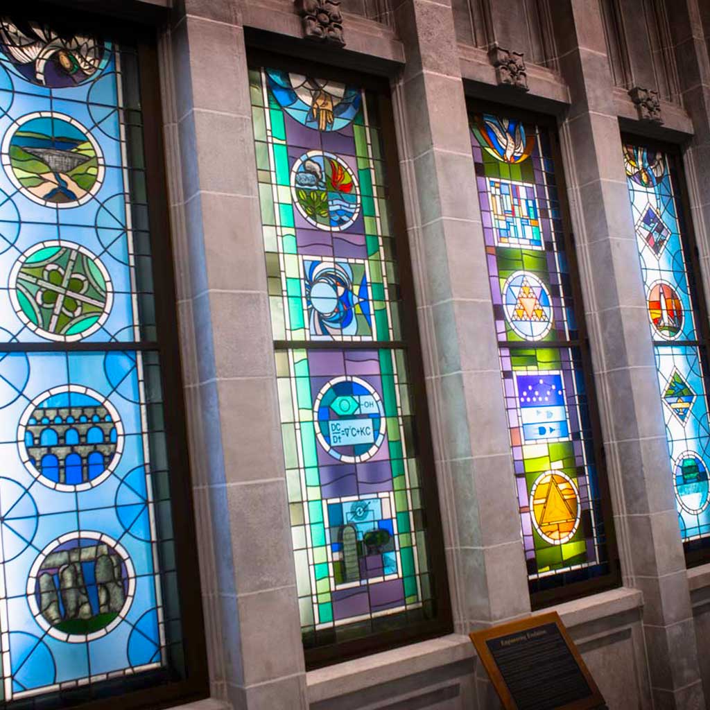 The stained glass windows inside Fitzpatrick Hall of Engineering that represent the engineering disciplines at Notre Dame